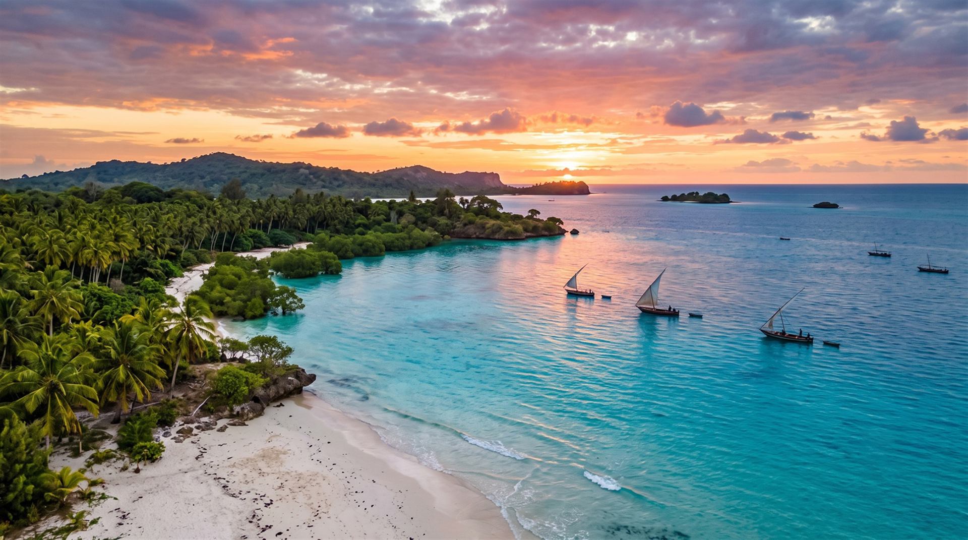 Aerial view of Mafia Island's turquoise waters and dhows at sunset